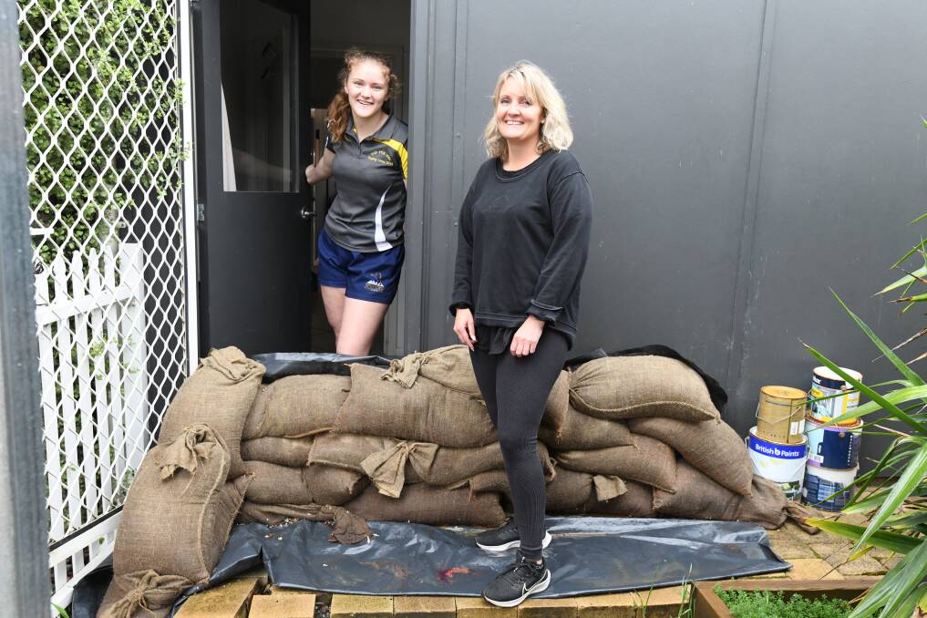 Sarah (R) and Lily Bone have barricaded 17 Shades Hair Salon in Molong to try and avoid a repeat of the 2021 floods. Picture by Jude Keogh
