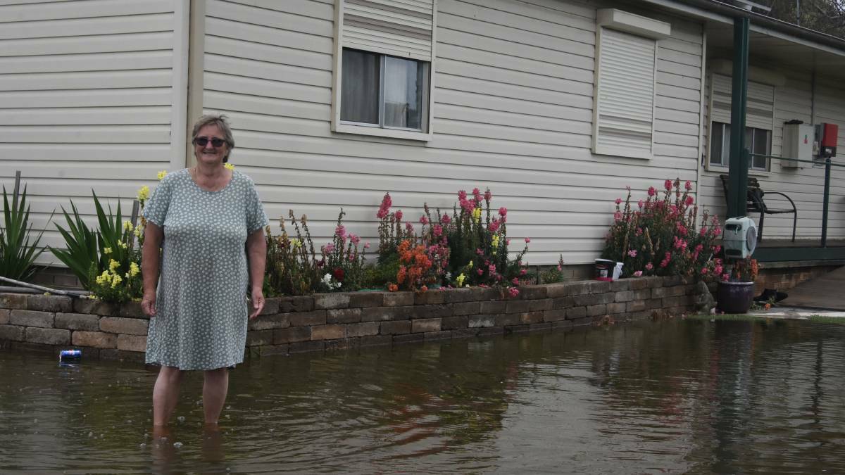 Lyall Street resident Christine Norton inspecting her property Monday. Picture by Andrew Fisher.