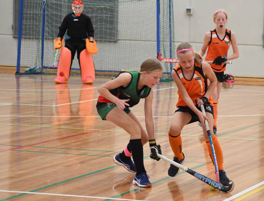 Charlotte Toole and Stella Mitchell battle as Orange plays Goulburn in the under 13s division 2 match. Picture by Carla Freedman