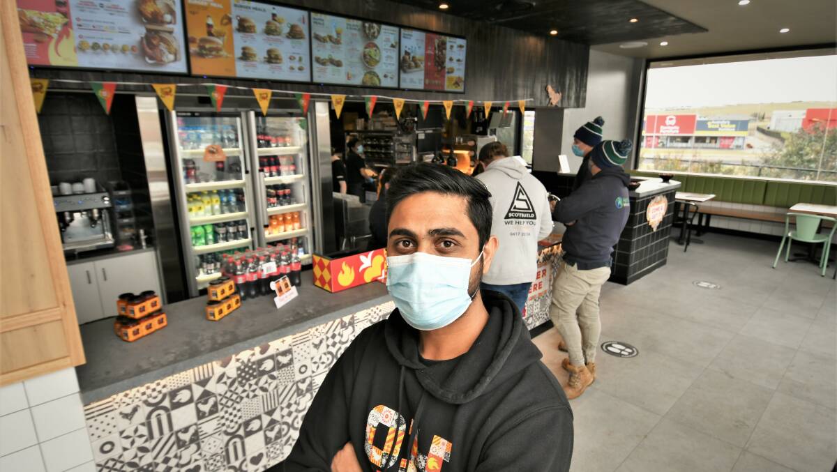 MAD RUSH: Oporto Bathurst franchise owner Nilesh Patel says he was happy with the restaurant's first day. Photo: CHRIS SEABROOK