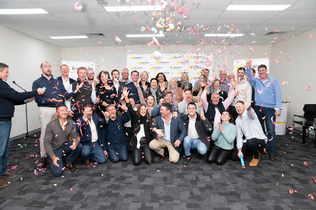 SMILES: The Ray White Emms Mooney team celebrating. Photo: SUPPLIED