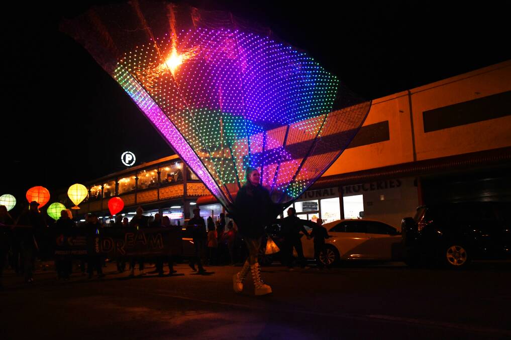 A dancer wearing an illuminated peacock tail led the lantern parade down Talbragar Street. Picture by Amy McIntyre