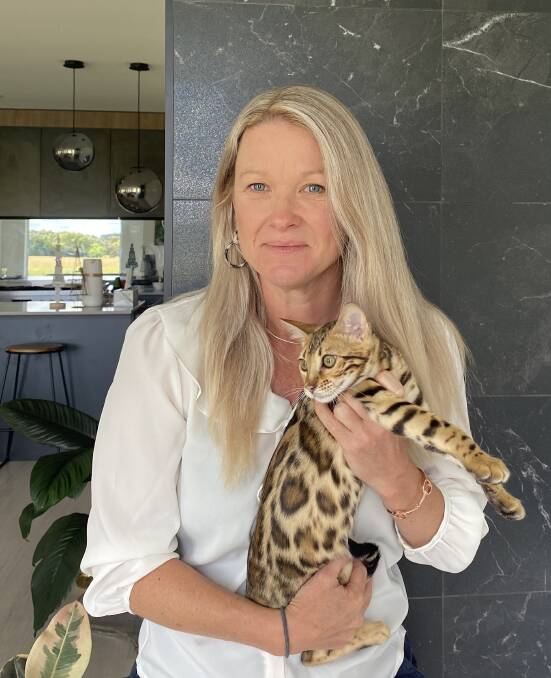 BREED OF THEIR OWN: Amy McKenzie with Gucci Tigerlilly, one of her Bengal cats.