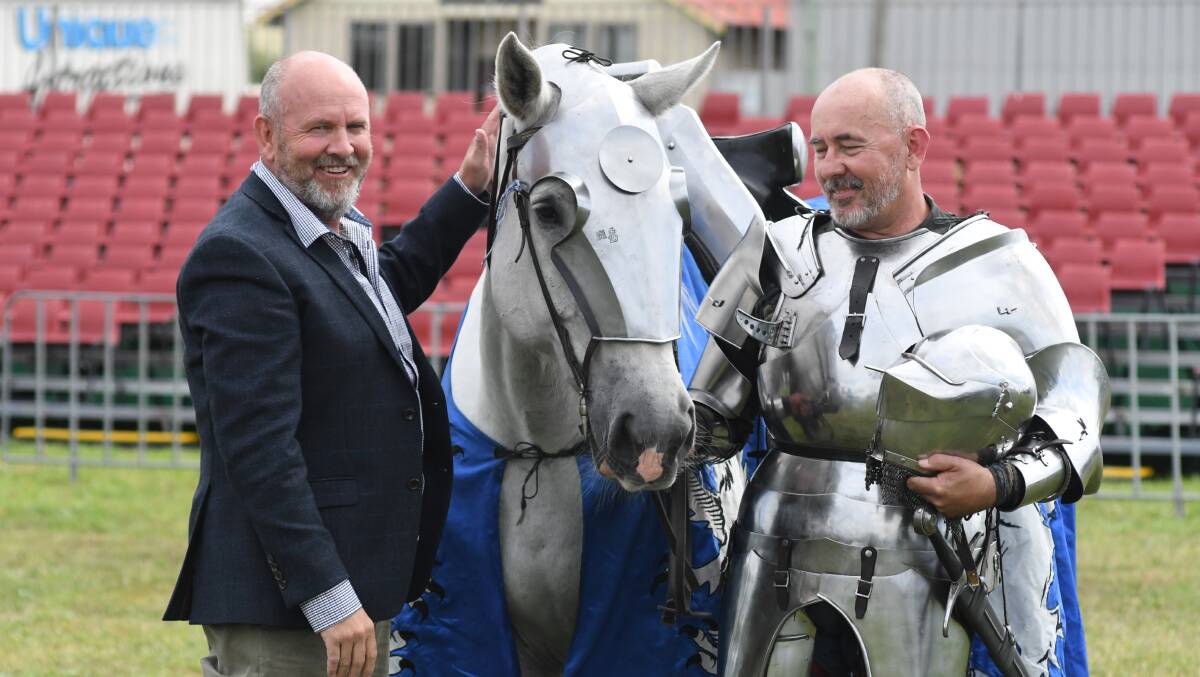 WAR HORSE: Orange mayor Jason Hamling meets the mighty Navarre, and 11 year old percheron, who will feature in the jousting this weekend with his Knight Andrew McKinnon. Photo JUDE KEOGH