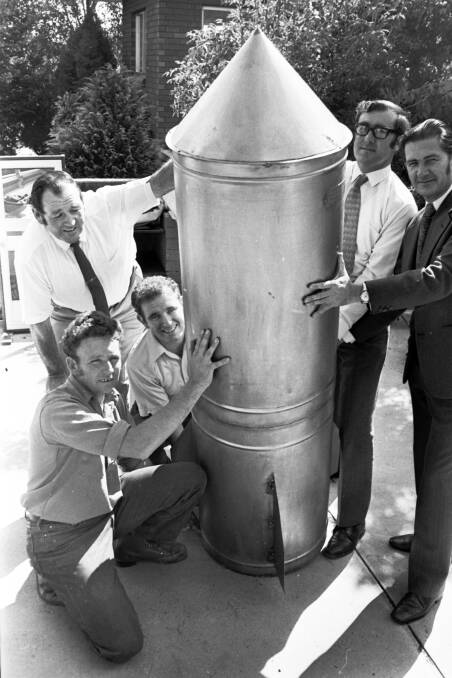 The Central Western Daily photo from March, 1973 of Orange Lions Club members with the capsule to be buried in Robertson Park. Pictured are project chairman Jim Moore (standing at left), Geoff Newham (front, kneeling), and Robert Dumesny. At right are Orange Lions Club president Ted Evans and club member Don Mearns. Photo courtesy of the Orange Historical Society