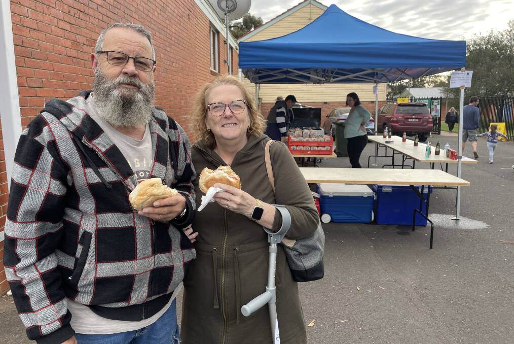 FOOD FOR THOUGHT: Graeme Ross and Lynne Hooper tucked into a bacon and egg roll at the Bletchington Public School polling booth on Saturday morning.