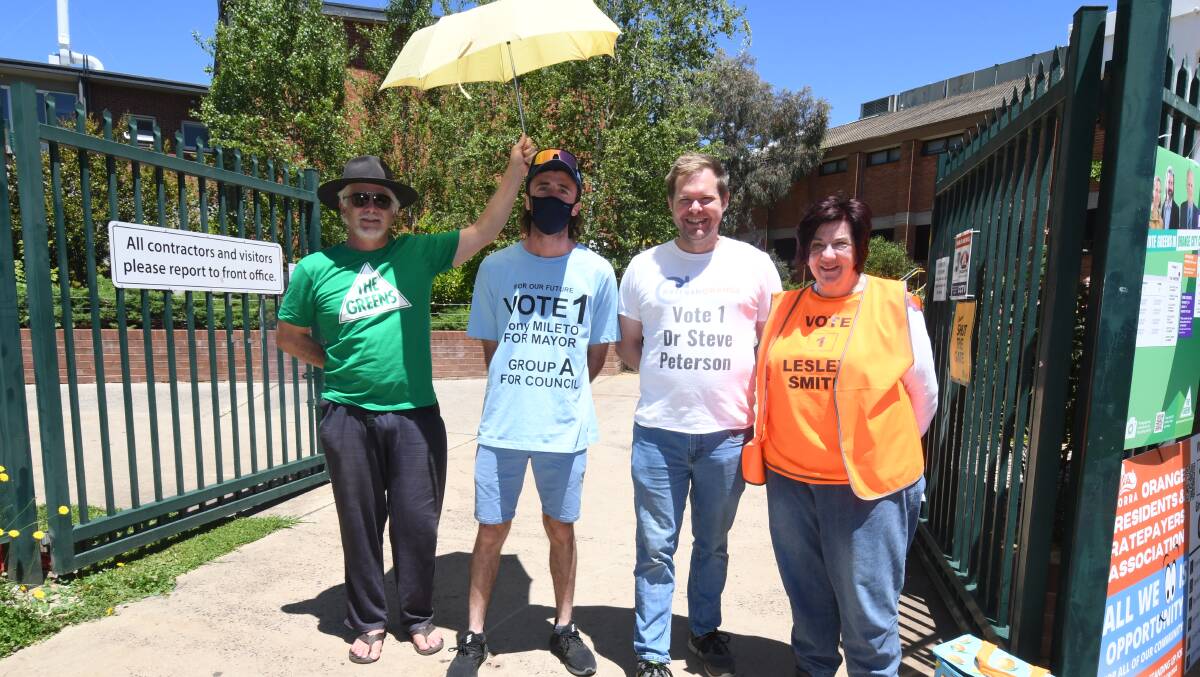 FRIENDLY RIVALRY: Supporters Tony Caine and Bill Thompson, with candidates Theodore Crane and Lesley Smith at Orange High's polling booths. Photo JUDE KEOGH