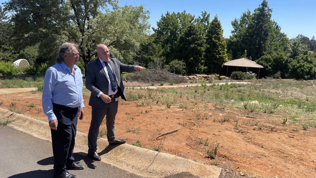 Graham Gentles and Nathan Whiteside look over the proposed development site. The new building will be double the size of the clubhouse which was destroyed by fire in 2019.