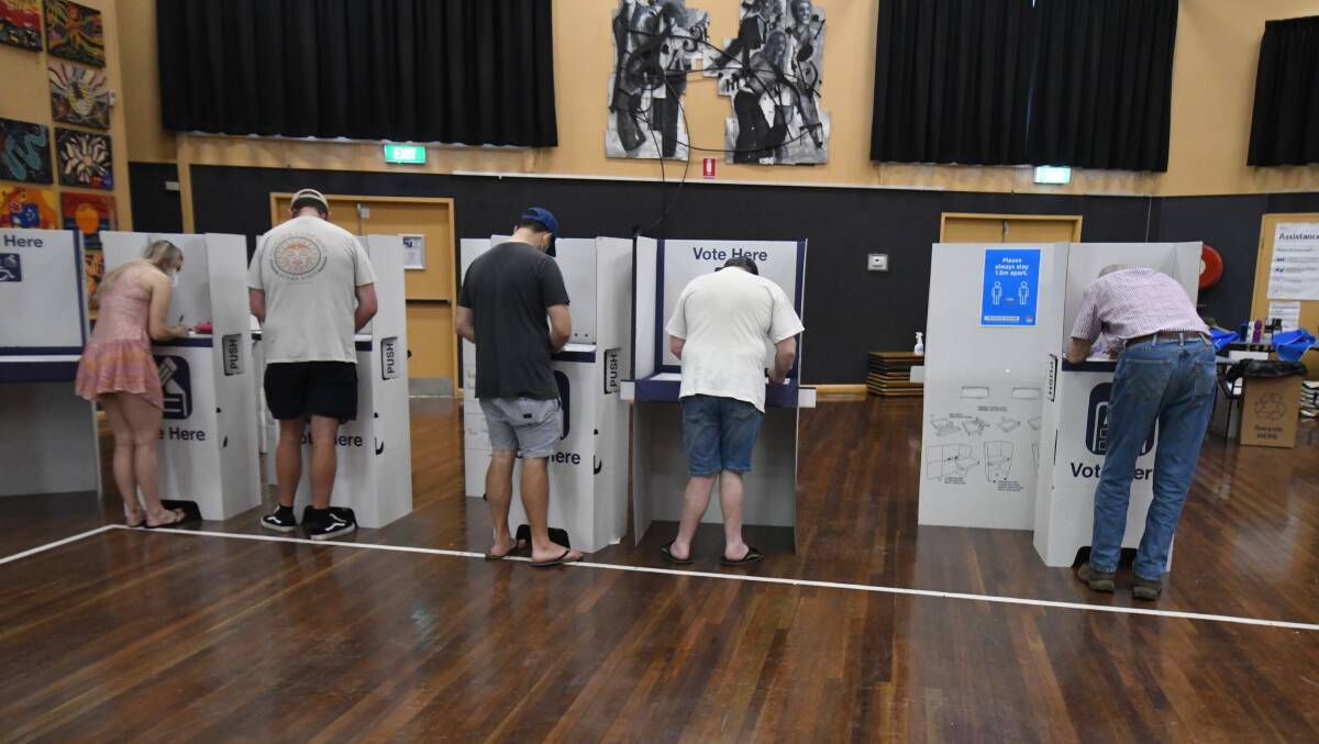 DECISION PENDING: Voters make their decision at Orange High School's polling booth. Photo JUDE KEOGH