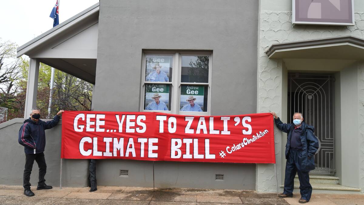 GRAND GESTURE: Rob McLaughlin and NIck King with the banner outside Member for Calare Andrew Gee's office in Orange. Photo CARLA FREEDMAN