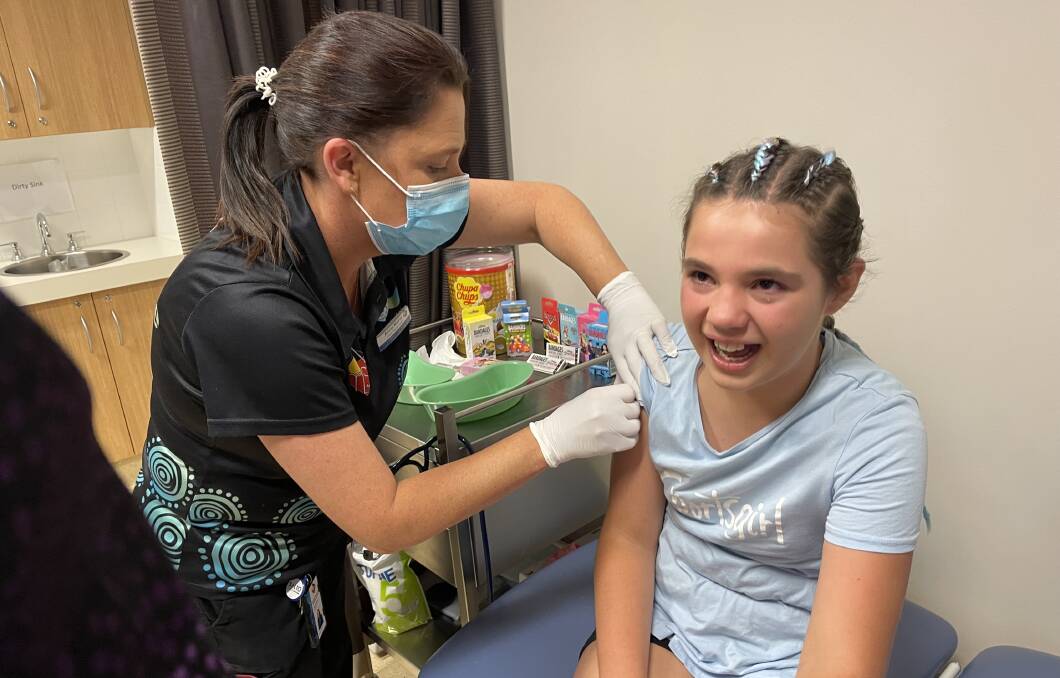 ROLLING UP HER SLEEVE: Mahli Newman, 11, has her first COVID-19 vaccination, administered by clinical lead nurse Anne-Marie Mepham at the Orange Aboriginal Medical Service.