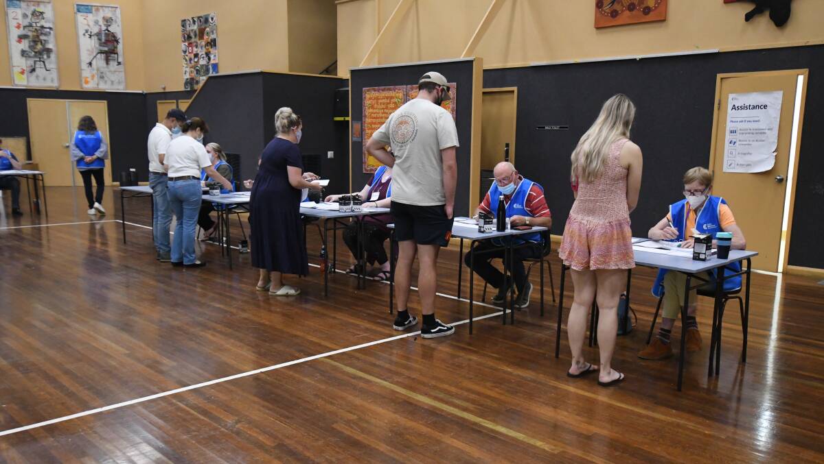 THOROUGH PROCESS: Residents cast their vote at the Orange High School polling booths. Orange won't know the result of its local government election until December 22. Photo JUDE KEOGH