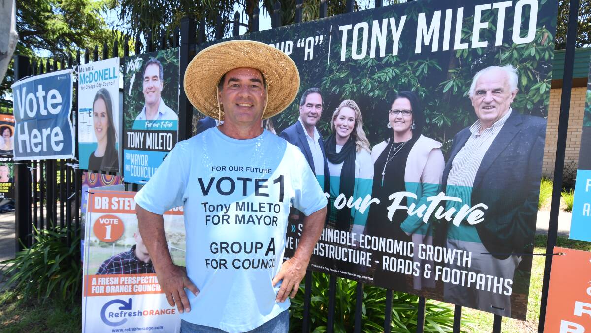 ON THE HUSTINGS: Tony Mileto campaigns on election day outside Calare Public School. Photo JUDE KEOGH