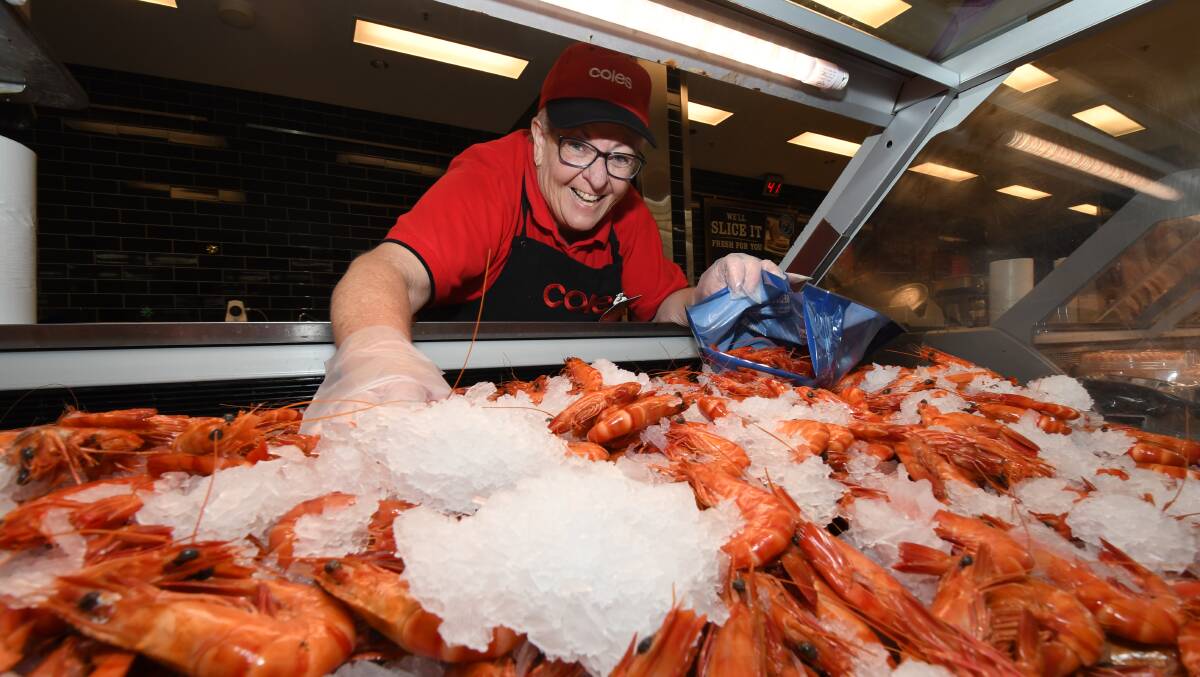 PRAWN CENTRAL: Coles Orange delicatessen manager Julie Robinson packs up an order of prawns on Wednesday. Photo JUDE KEOGH
