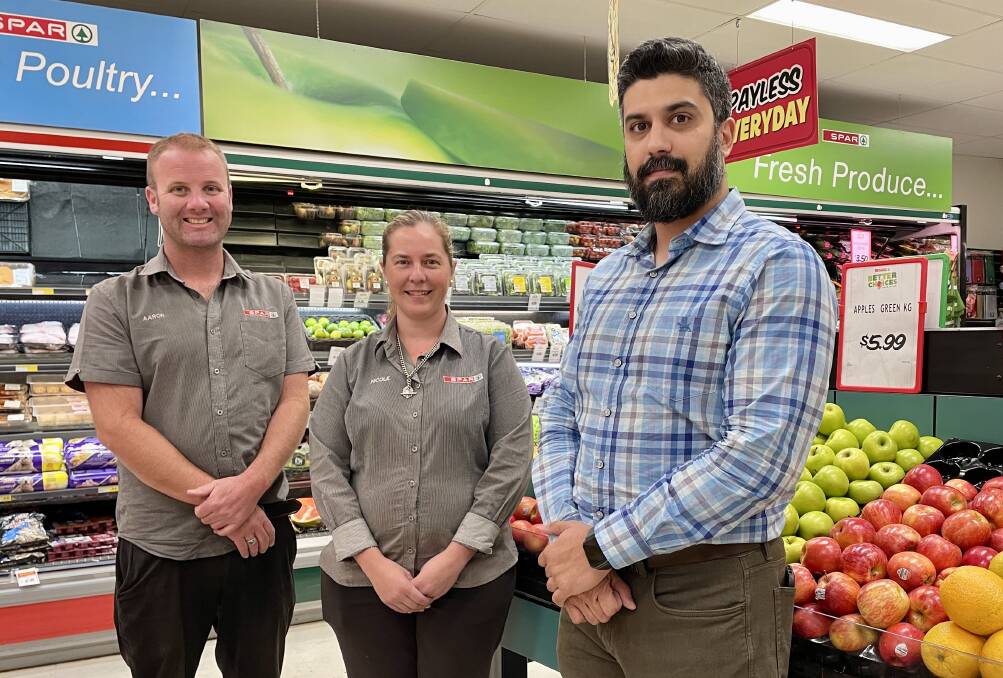 CHANGE: SPAR's assistant manager, Aaron Whiley and store manager, Nicole Gosper with new owner of the Molong supermarket, Ghazanfar Ahmedi. Photo: EMILY GOBOURG.