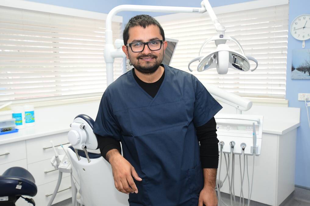 SETTLING: Kite Street Dental's newest associate dentist, Dr Bashudev Mainali said 'Orange is beautiful' with he and his family settling in very well since July 19. Photo: JUDE KEOGH.