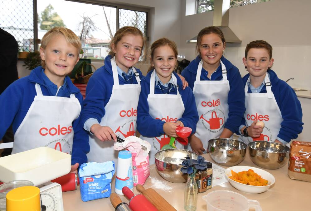 COOKING IN STYLE: A mix of years 3 and 4 students from Calare Public School, Jenson Purss, Alice Duedren, Laura Harrison, Claudia Jones and Levi Sherlock on the grand opening day of their new cooking hub. Photo: CARLA FREEDMAN.