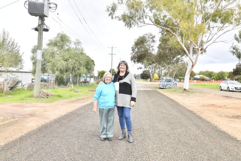 Six-months on, Eugowra's flood survivors Mavis Cross and daughter-in-law, Sue Cross, stand in the middle of Aurora Street; a place where tragedy was narrowly avoided. Picture by Jude Keogh.