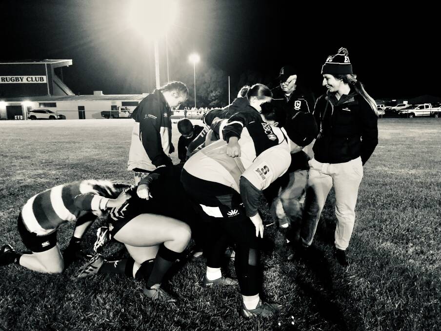 MENTALITY OF PACK: The 2022 women's side of Emus Rugby Union Club's practice scrums at training in April, with strength and conditioning coach, Lisa Onley by their side. Photo: CONTRIBUTED.