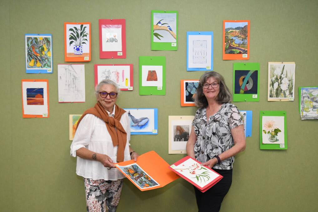 FORG HOSTS: Friends of Orange Regional Gallery president Maria Edwards with secretary Sue Olden getting ready for the Hidden Treasures exhibition, April 8-10. Photo: JUDE KEOGH.