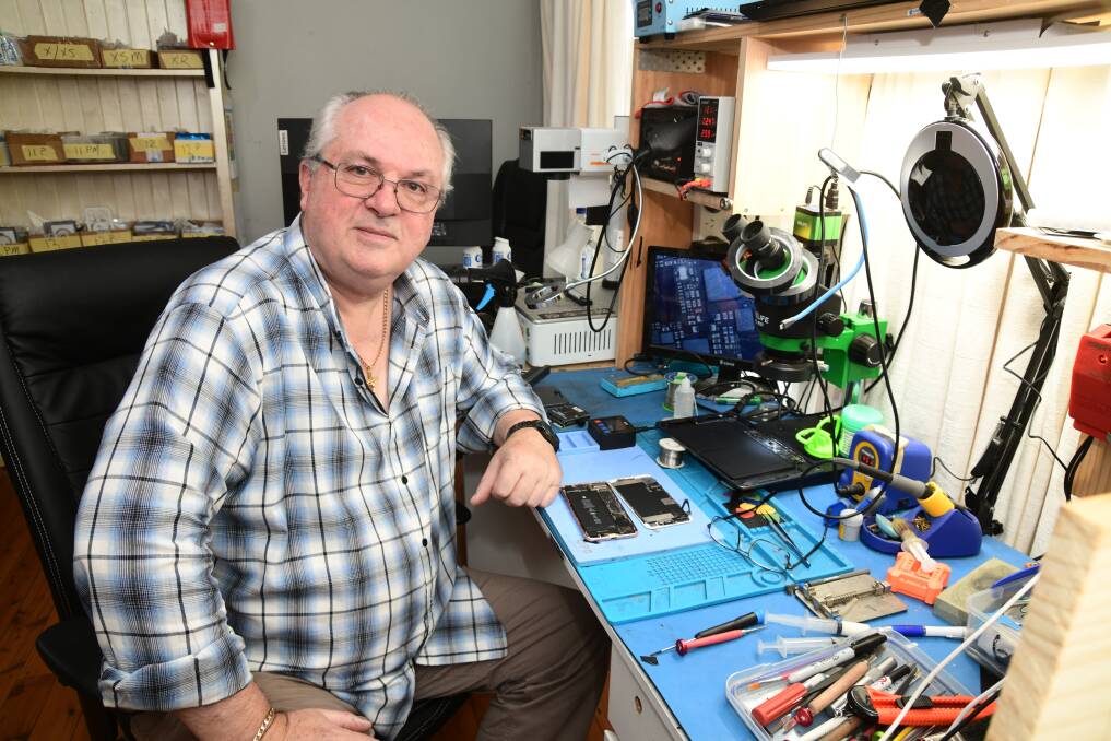 Phone and computer repair technician and owner of Orange's MePhone, Keith Rogers works from home on Molong Road. Picture by Jude Keogh.