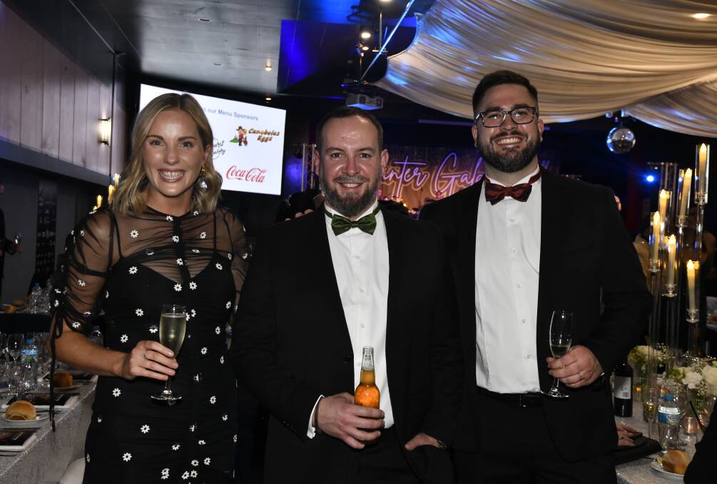 Danielle Farrimond, Chad Ferris and Jared Griffiths amid Saturday night's Ronald McDonald House Charities Central West winter gala ball, July 15. Picture by Jude Keogh.
