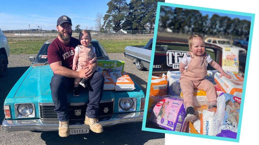 Dad Darcy Garlick with his daughter Isla Garlick, both proudly part of The Nappy Collective's #dadschangenappiestoo on the bonnet of a teal Kingswood. Pictures supplied.