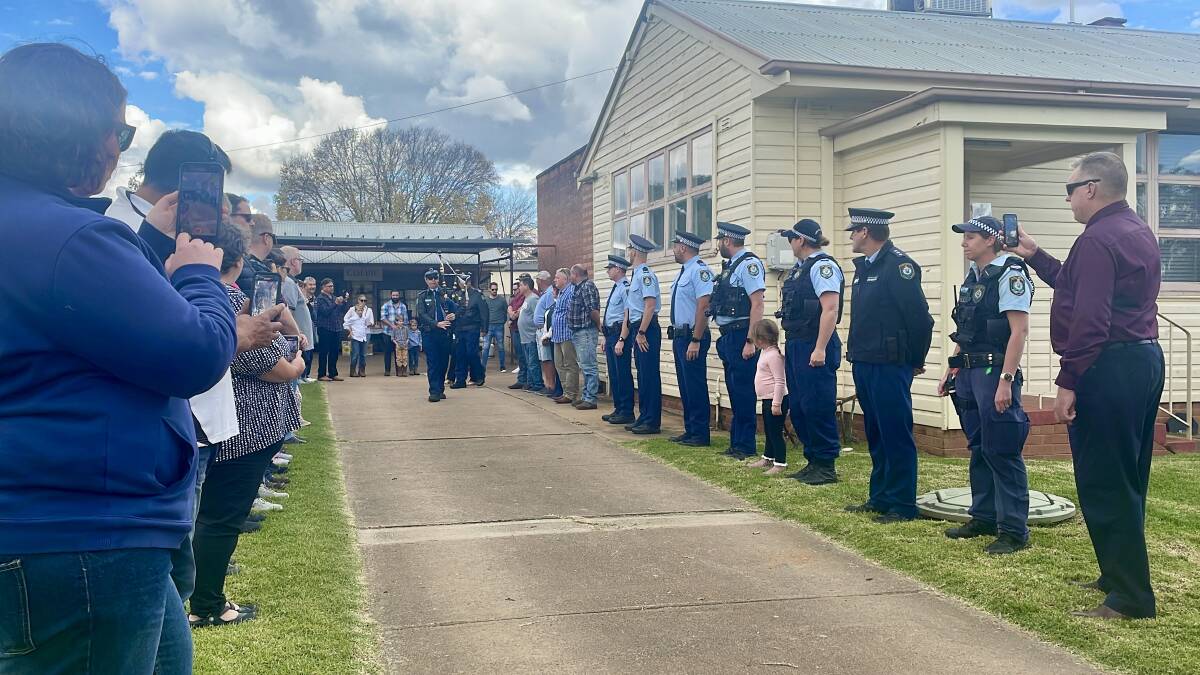 SALUTE: Colleagues, residents, friends and family line the station's pathway in a guard of honour, saluting Cudal's long-serving police officer. Photo: EMILY GOBOURG.
