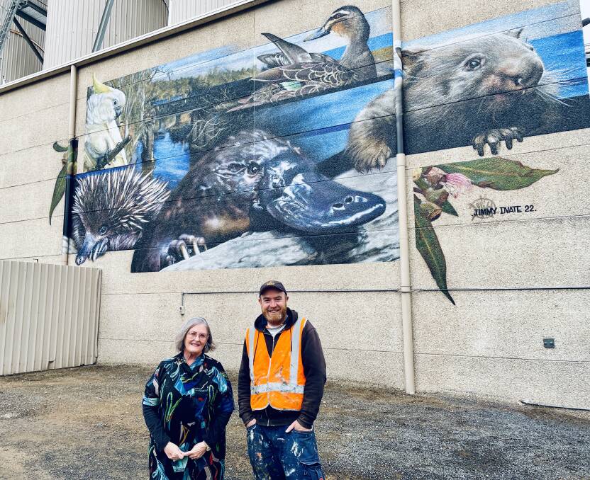 SUCCESS: Manildra's Sue Reynolds and renowned Melbourne street artist, Jimmy Dvate are equally proud of the new artwork at 'the mill', said to represent the small town's well-known creatures. Photo: EMILY GOBOURG.
