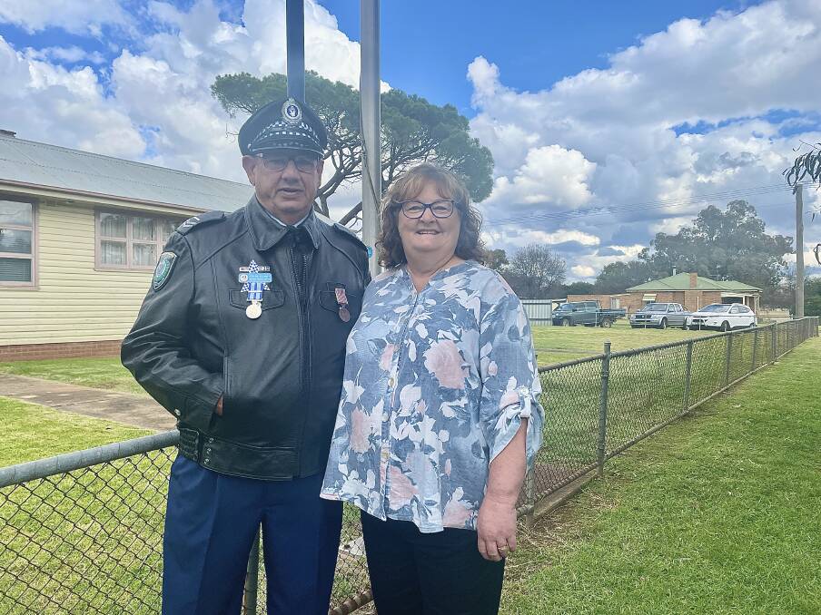 BIG FAREWELL: Senior Constable Colin "Col" Clunes with wife Vicki Clunes outside of the Cudal Police Station on Thursday for his last day of active service with the NSW Police. Photo: EMILY GOBOURG.
