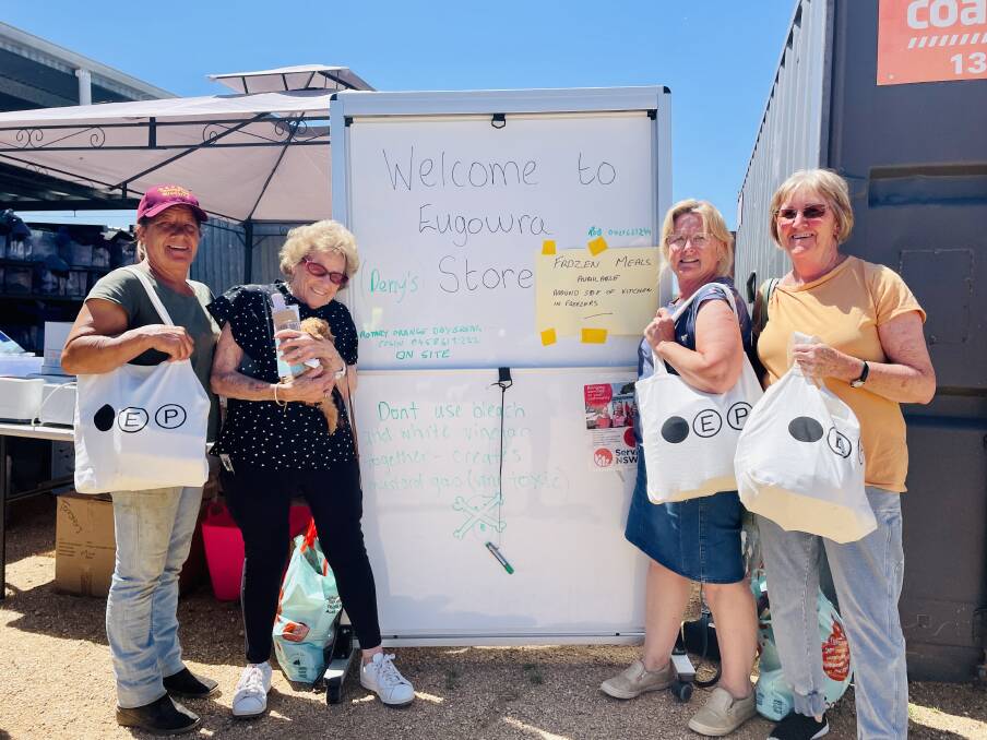 Eugowra residents Karen Gilchrist and Jeanette Norris with next-door neighbour Marianne Skeers and Liz Adams at the Eugowra Showground picking up food supplies on Wednesday, November 30. Picture by Emily Gobourg.