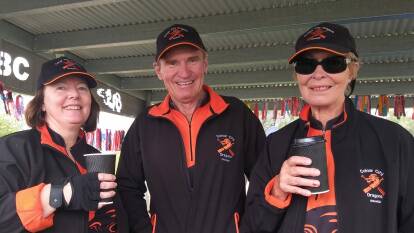 PADDLERS: Colour City Dragons members Jasmine Vidler, president John Moss and June Bennett enjoy a coffee during a day of dragon boat racing at the Parkes fourth anniversary regatta. Photo: SUPPLIED.
