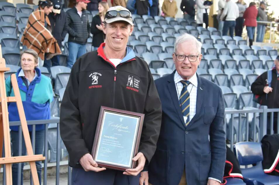 Peter Haynes was presented with a certificate of appreciation by president David Clifton for his dedication to New England Rugby Union. File picture.