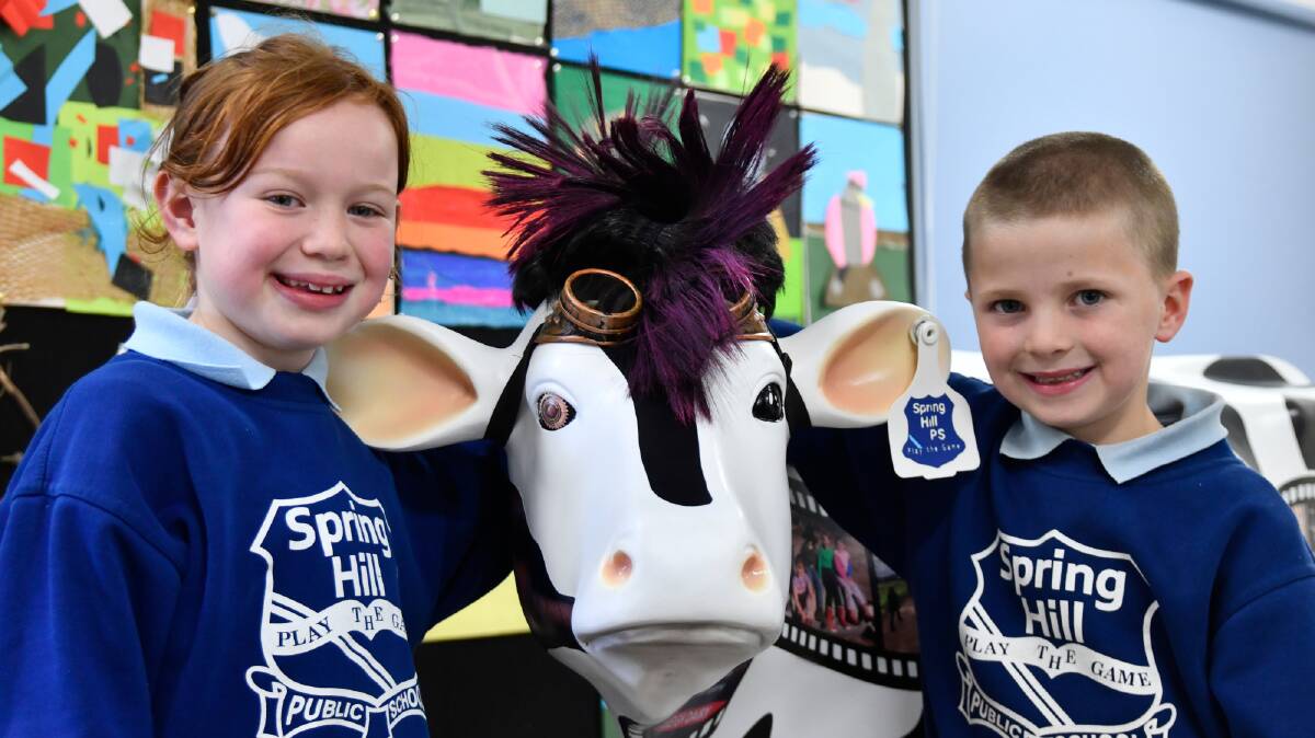 Mia Cantrill and Sonny Bennett with Poppy the Steampunk cow at Spring Hill Public School. Pictures by Carla Freedman 