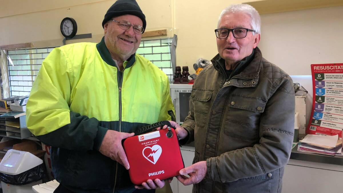 Orange Men's Shed President Alan Campbell (left) and Wayne Gallagher (right) with the new Philips 'Heartstart' defibrillator 