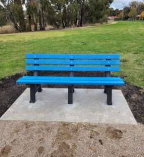 The first of 13 blue benches set to be installed in Orange. This one is located in Pilcher Park. 