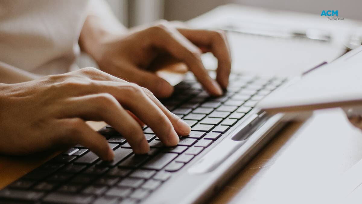 Stock image of a person typing on a computer keyboard. Picture Canva