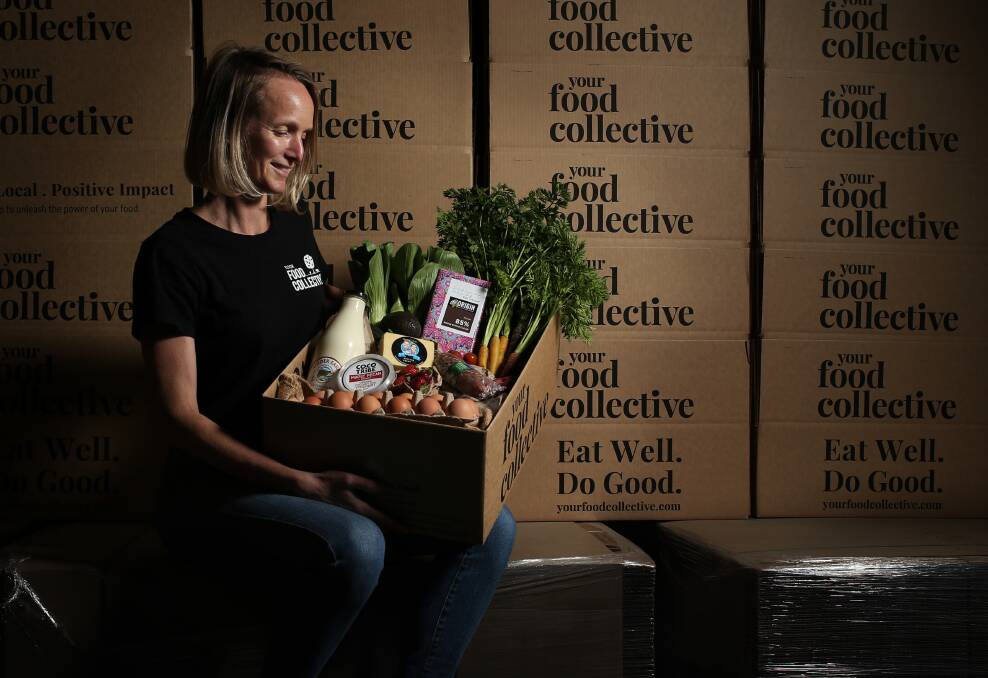 Fresh: Lauren Branson with a bespoke box of produce and goods at the company's Tighes Hill warehouse. Picture: Simone De Peak