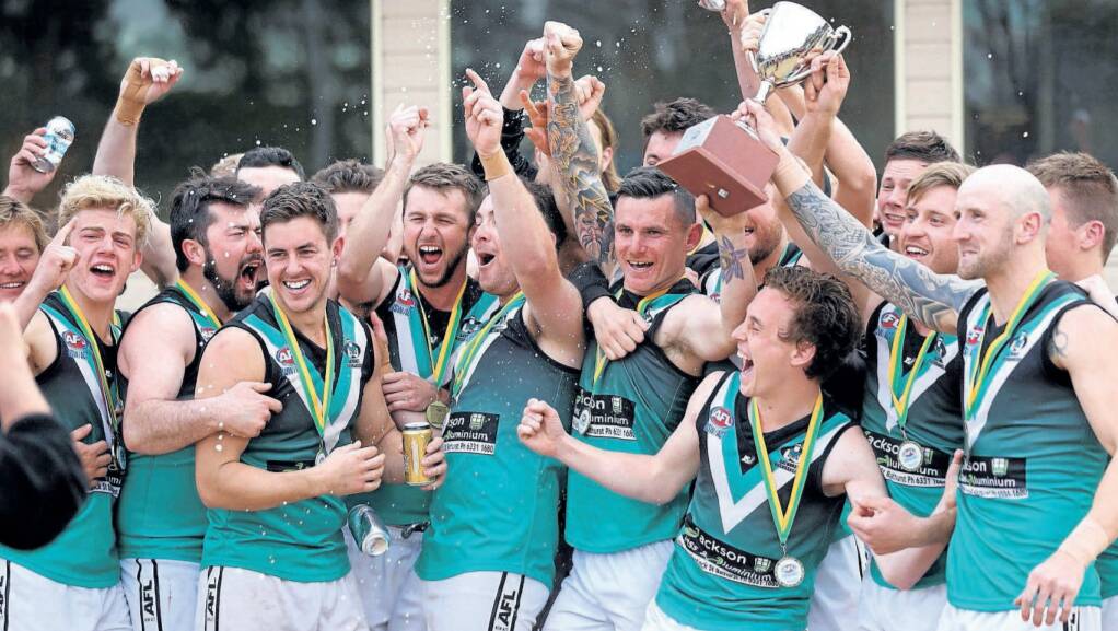 THE BATHURST BOYS ARE HAPPY: The Outlaws celebrate their Central West AFL grand final win over Orange in 2017. Photo: PHIL BLATCH