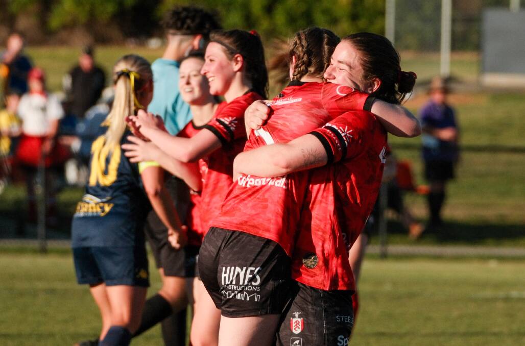Panorama players Emily Cochrane and Sarah Colman embrace after winning Sunday's Bathurst District Football women's grand final. Picture by James Arrow