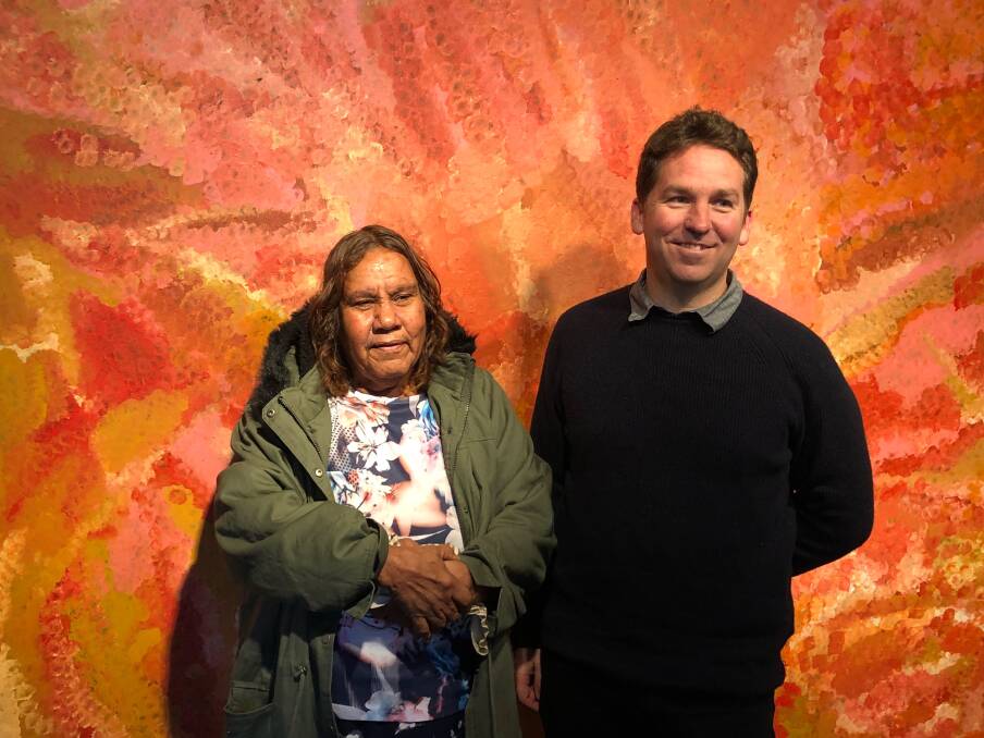 Powerful Artwork: Margaret Loy Pula with Director, Bradley Hammond in front of a painting by Emily Kame Kngwarreye. Some of Australia’s foremost contemporary painters.