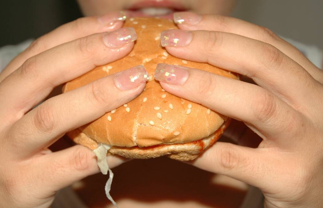 WELL HELD: They say you should use both thumbs and little fingers to hold the bottom and the three middle fingers to hold the top of the bun in place. Photo: FILE PHOTO
