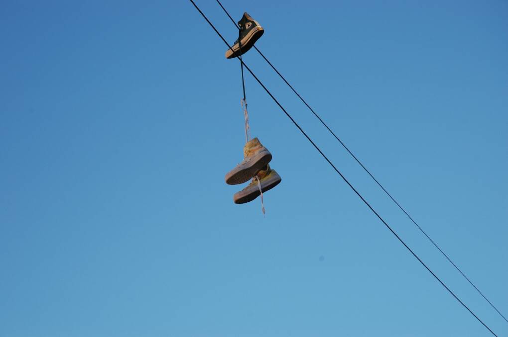 BOOTS AND ALL: The latest shoes tossed over wires in McNamara Street make for interesting street 'art'.