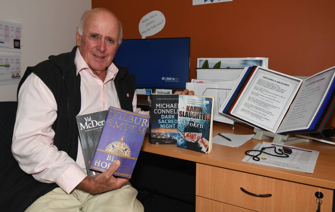 DOING IT BY THE BOOK: Lifeline Central West Executive Director Alex Ferguson with some of the page-turners that will be on offer at this weekend's book fair in the Orange Showground's Naylor Pavilion. Photo: CARLA FREEDMAN