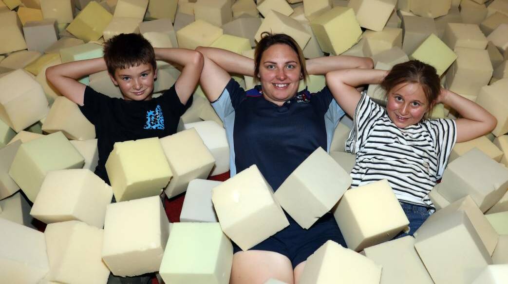 KICKING BACK: Morgan Thurtell, Shana Coles and Emma Jurd relaxing in a sea of foam blocks at PCYC Orange.