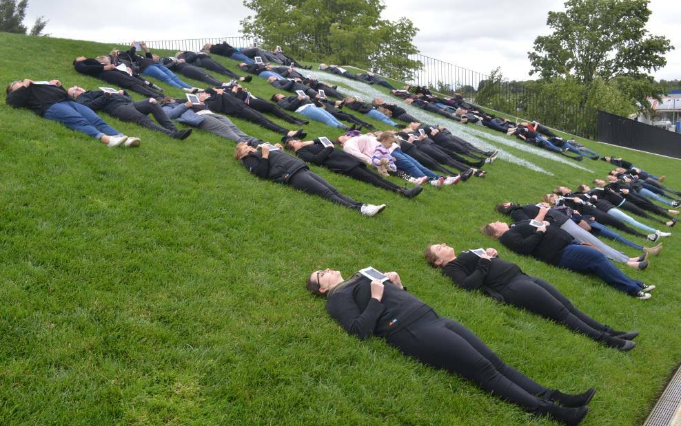 SILENT PROTEST: A group of volunteers lay down on the roof of Orange Regional Museum to represent the women killed this year through domestic violence. Photo: ALEX CROWE