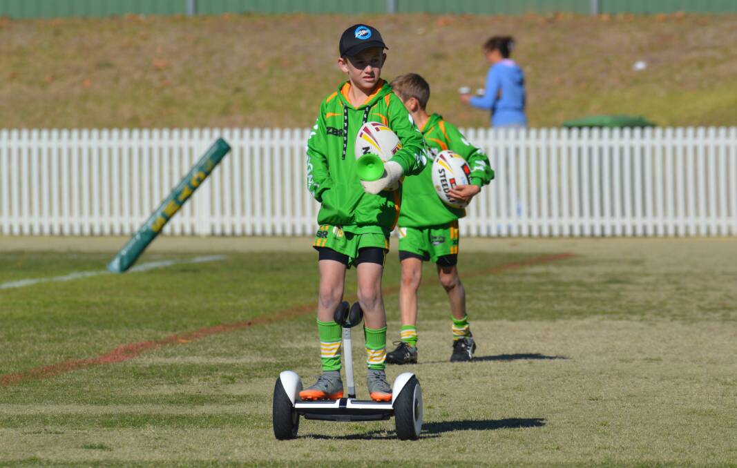 WHY WALK?: The ball boy scoots his way off Wade Park on Sunday afternoon. Photo: MATT FINDLAY