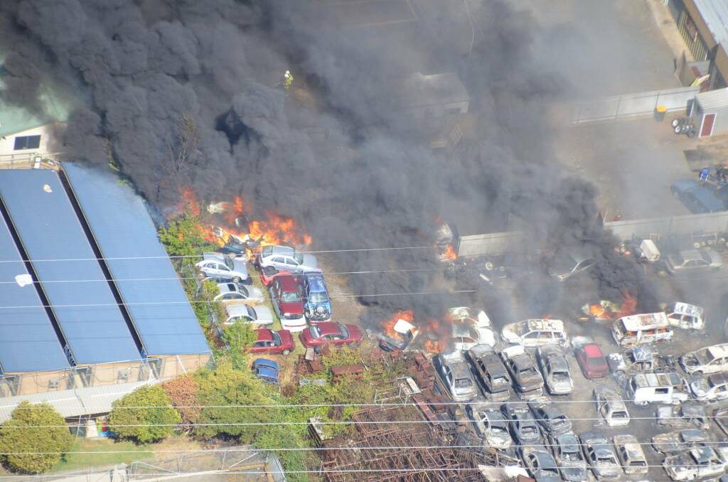 MASSIVE DAMAGE: Saturday's blaze destroying the holding yard of JG Auto Sales in William Street. Photo: PETER BRUS and ORANGE HELICOPTERS