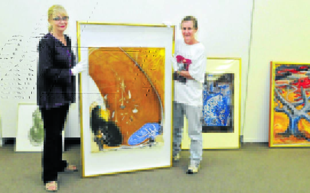 HAPPY DAYS: Brenda Gray and Catherine Phillips with a Brett Whiteley painting that was shown as part of the exhibition in 2014. Photo: JUDE KEOGH 0429art4