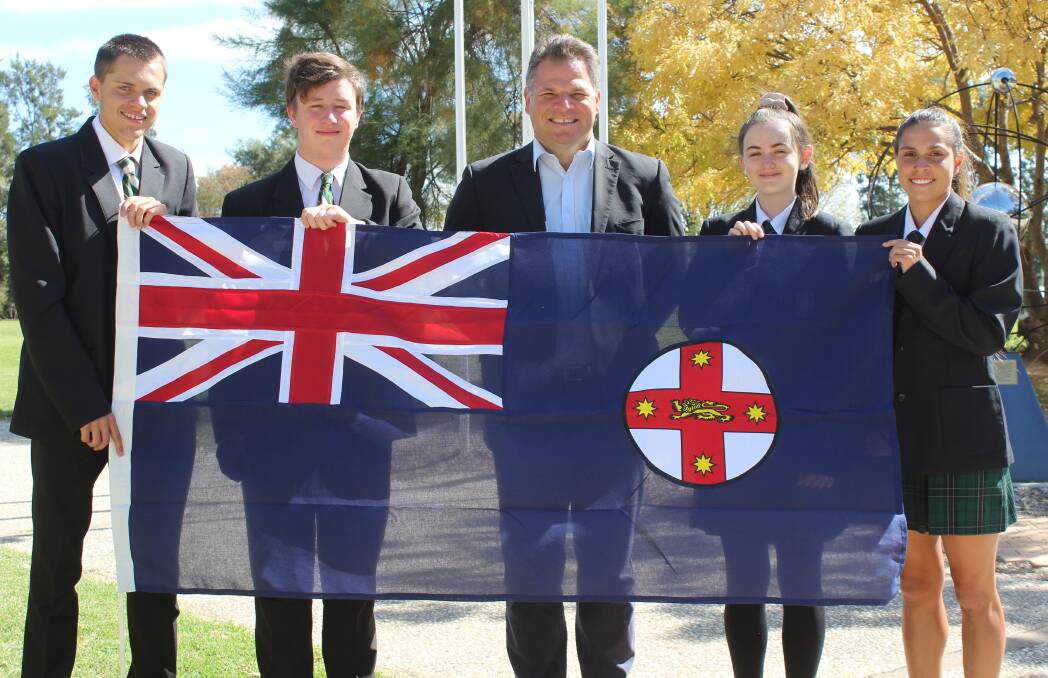 PROUD: Member for Orange Phil Donato presenting the NSW flag to Canobolas Rural Technology High School students Callan Naden, Justin Alexander, Catherine Nicholson and Erin Naden.